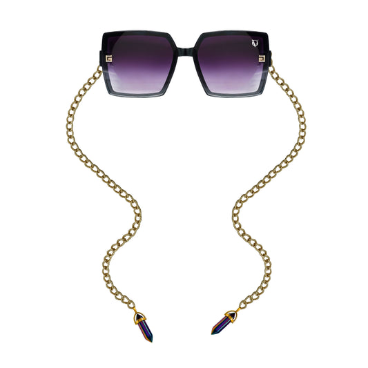 Square sunglasses with dark purple gradient lenses attached to a golden chain featuring gold detailing-front view