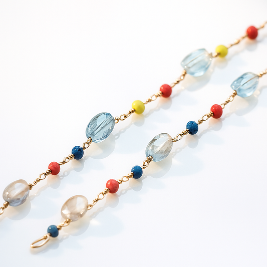 Gold chain with purple gemstone beads in a disc shape linked to colorful beads