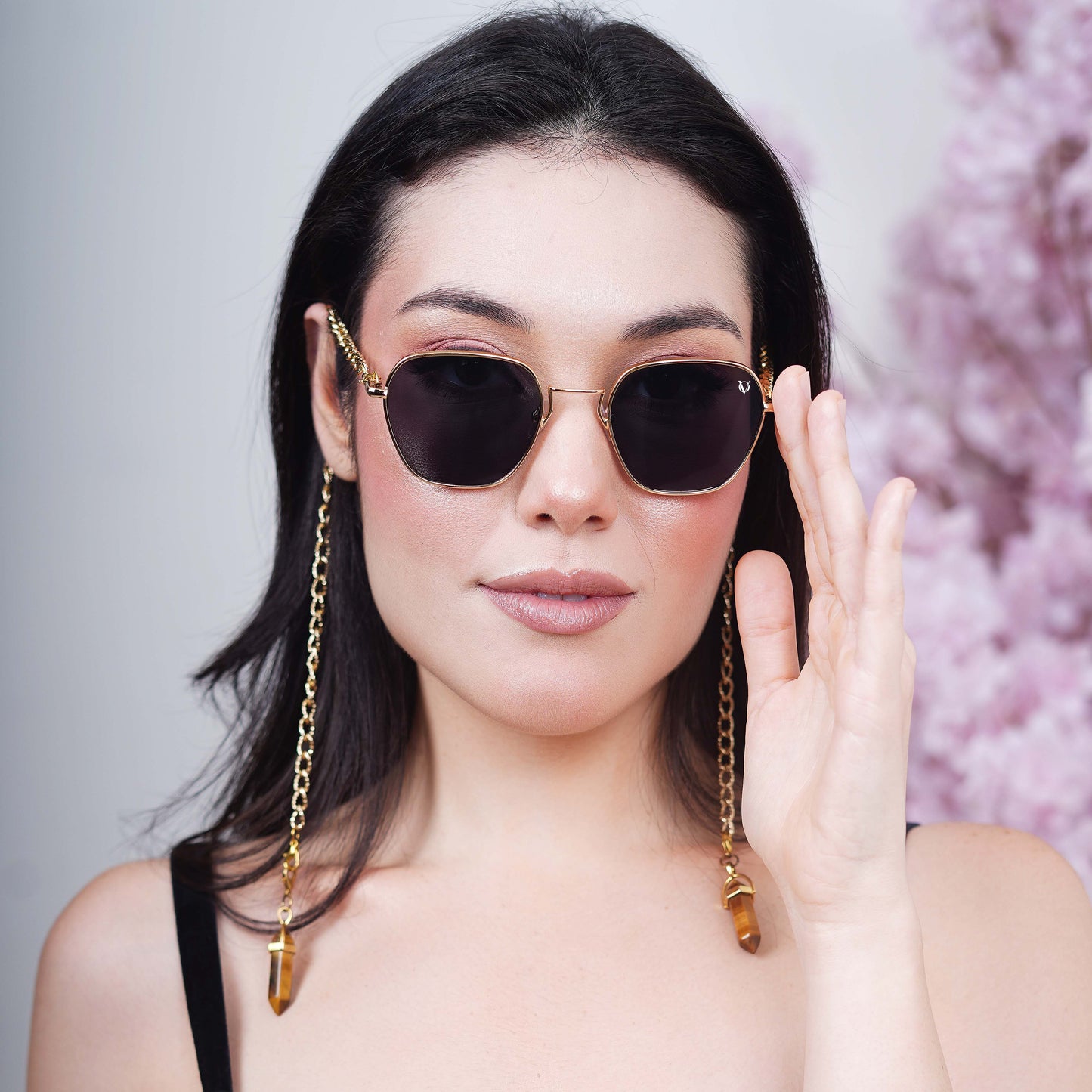 Black tinted large lenses with gold finishing attached with a golden chain with golden clear lenses finished with a gold metal holder-front pose