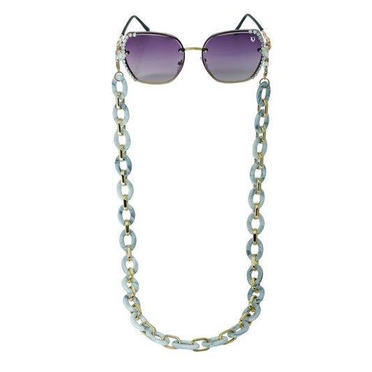 Sunglasses with gradient lenses attached to a bold chunky white chain -front view