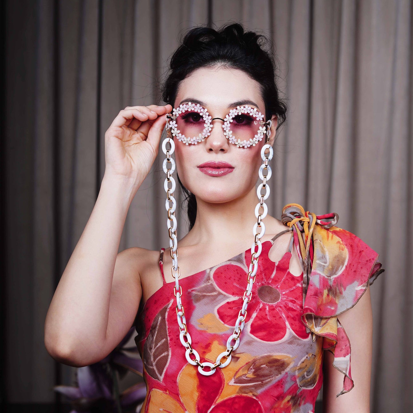 Elegant round sunglasses with floral crystal-studded finishing, adorned with a white funky chain for a playful vibe-front view