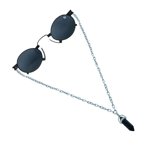 Round black sunglasses with a silver chain featuring a black crystal pendant-angle view