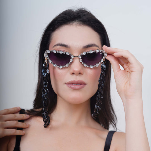 Glimmery oval crystal-studded cat-eye frames with purple gradient lenses attached with a blue-black gradient chain for fashion lovers-front view