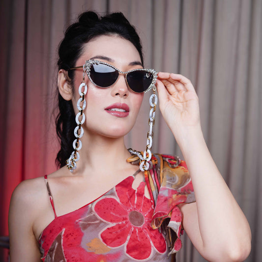 Best crystal-studded cat-eye frames sunglasses with a white chain linked with a gold linker for women's to go to a party-side view