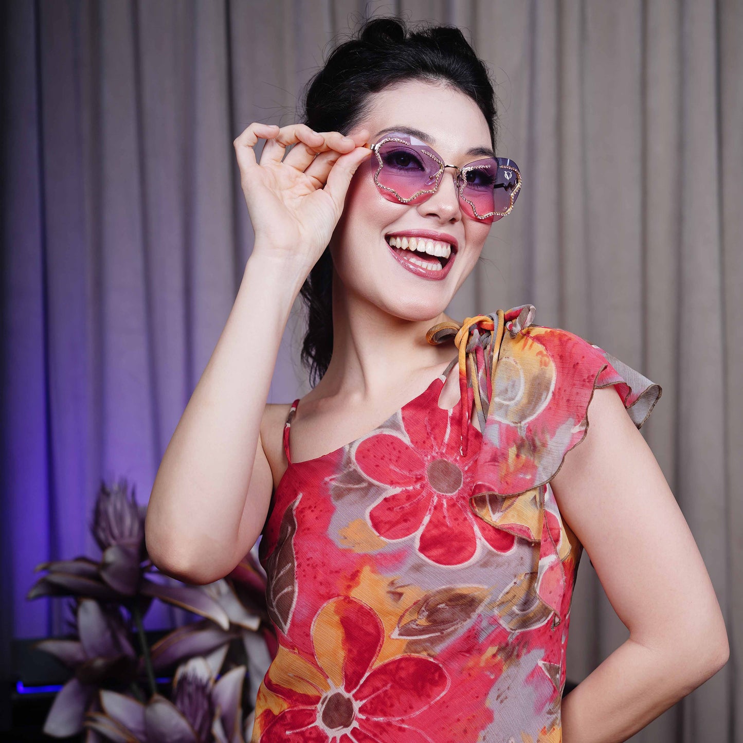 stylish heart-shaped sunglasses with purple-pink gradient lenses and a decorative golden frame-smiling view