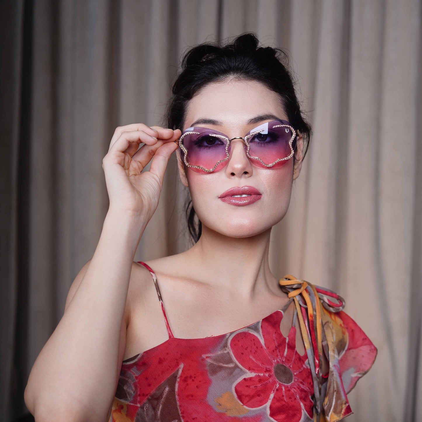 stylish heart-shaped sunglasses with purple-pink gradient lenses and a decorative golden frame-styling view