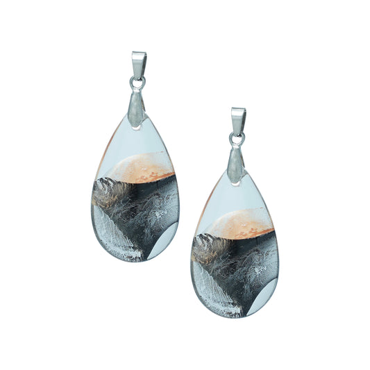 Teardrop-shaped glass pendants with a gold and black swirl design and silver hooks-front view