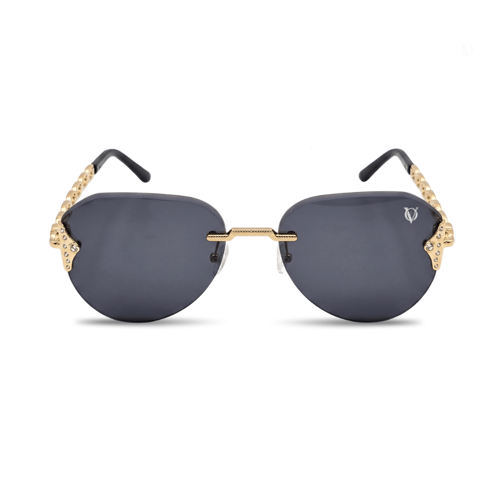 Sunglasses with gold frames and dark lenses on a white background