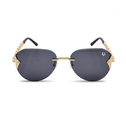 Sunglasses with gold frames and dark lenses on a white background