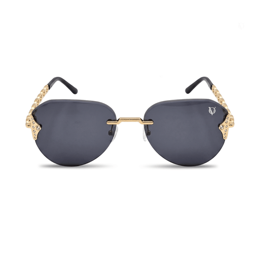 Sunglasses with gold frames and dark lenses on a white background