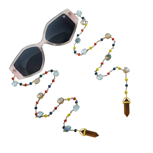 Blush-frame sunglasses with dark lenses and a colorful beaded chain featuring crystals and golden charms-angle view