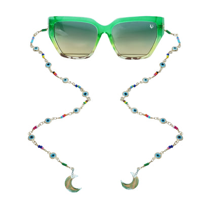 Green sunglasses with gradient lenses attached to a colorful beaded chain featuring evil eye accents and crescent shaped crystal pendants-front view