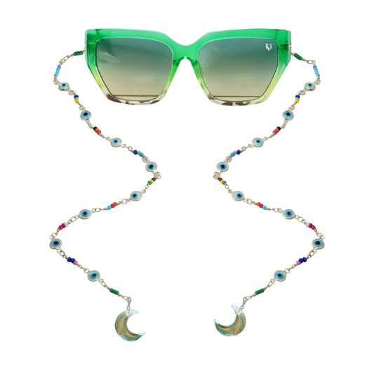 Green sunglasses with gradient lenses attached to a colorful beaded chain featuring evil eye accents and crescent shaped crystal pendants-front view