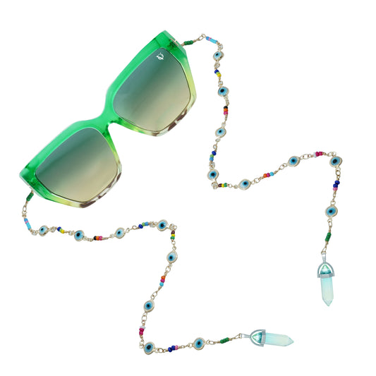 Green sunglasses with gradient lenses attached to a colorful beaded chain featuring evil eye accents and crystal pendants-angle view