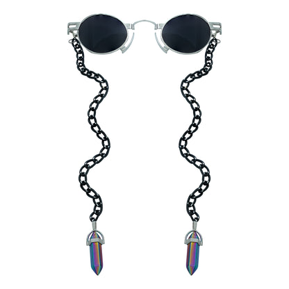 Round oval shaped sunglasses with a silver metallic frame attached to black chain, which holds a pendant shaped holographic vibrant crystal-front view