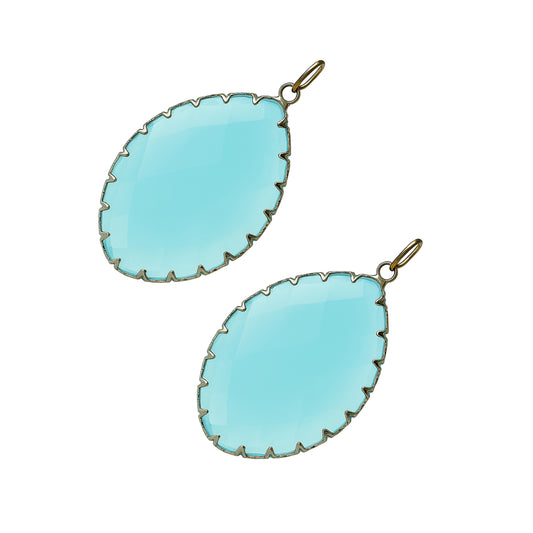 Teardrop-shaped aqua blue gemstone pendants with a gold prong setting-angle view