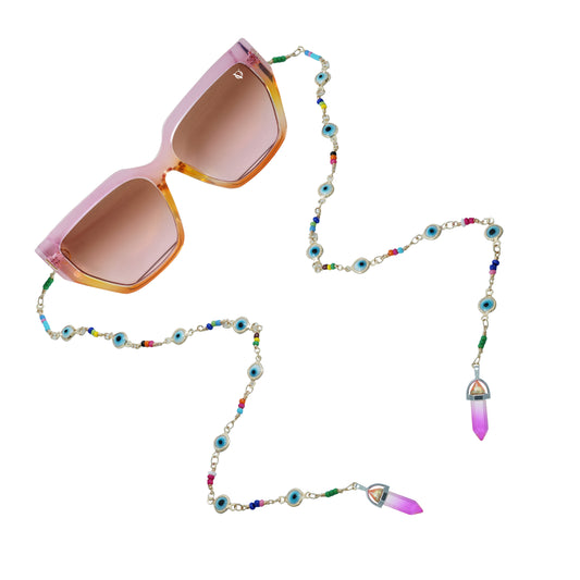 Brown sunglasses with brown gradient lenses attached to a colorful beaded chain featuring evil eye accents and crystal pendants-angle view