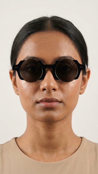 Person wearing dark sunglasses against a plain background