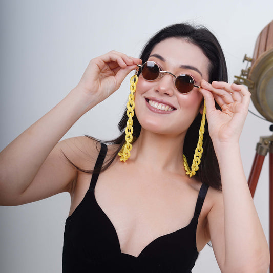 Small-sized sized charming, round, oval brown tinted shades lenses attached with a yellow funky chain-angle pose