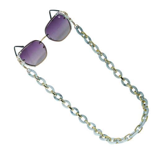 Sunglasses with gradient lenses attached to a bold chunky white chain-angle view