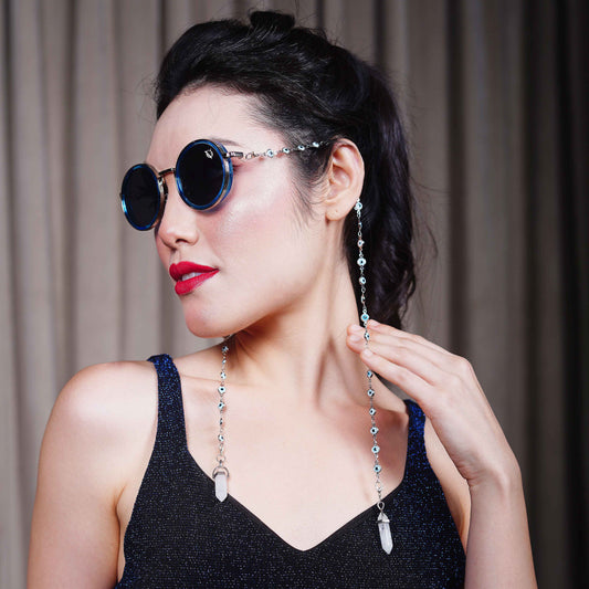 Trendy oversized blue round lenses adorned with a silver-tone evil eye chain and translucent white charm for a fashion statement-side view

