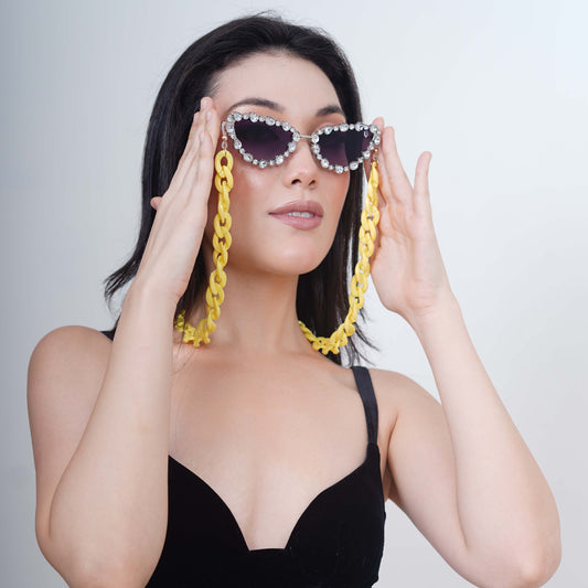 Glimmery oval crystal-studded cat-eye frames with blue gradient lenses attached with a yellow funky chain for trend lovers-front pose