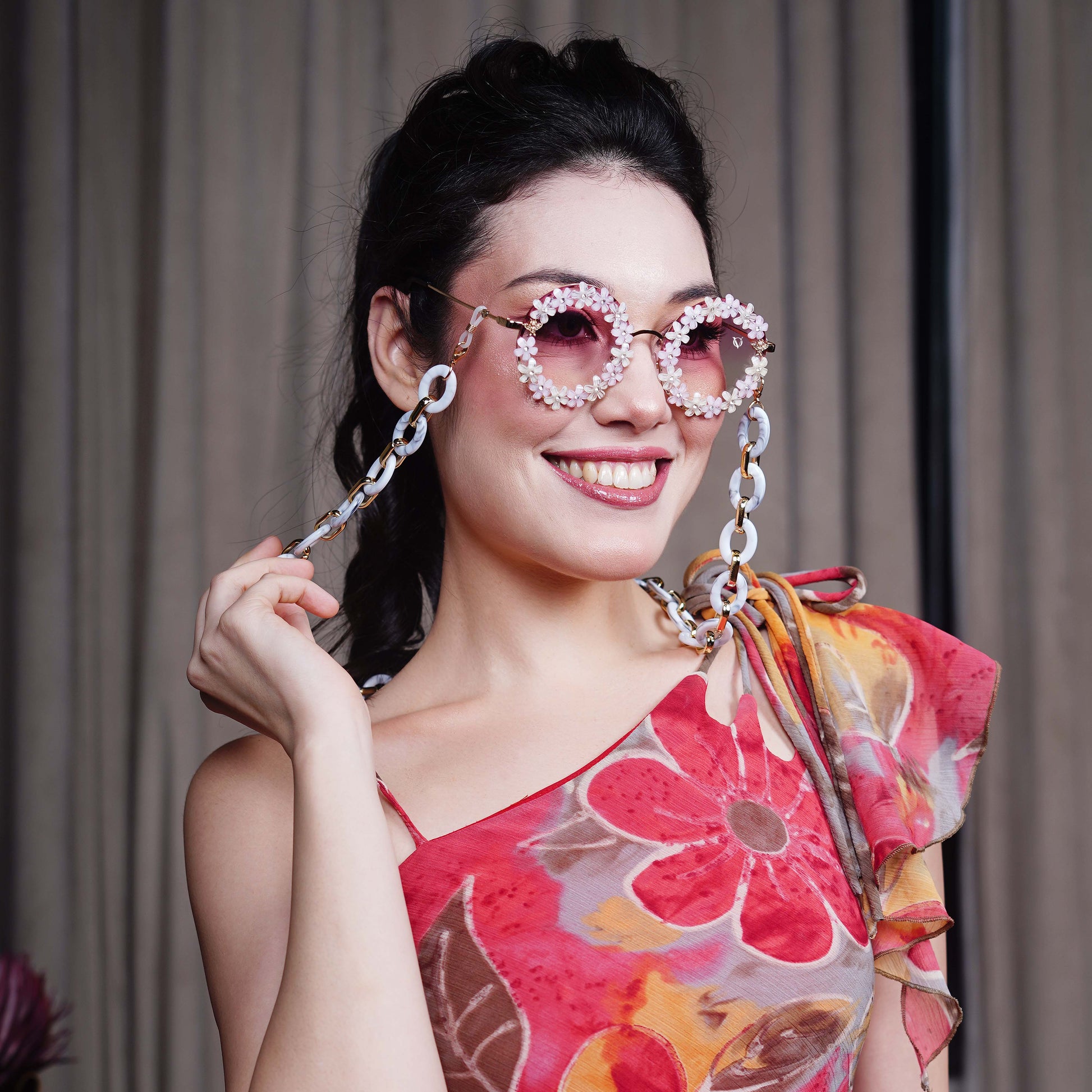 Elegant round sunglasses with floral crystal-studded finishing, adorned with a white funky chain for a playful vibe-styling view