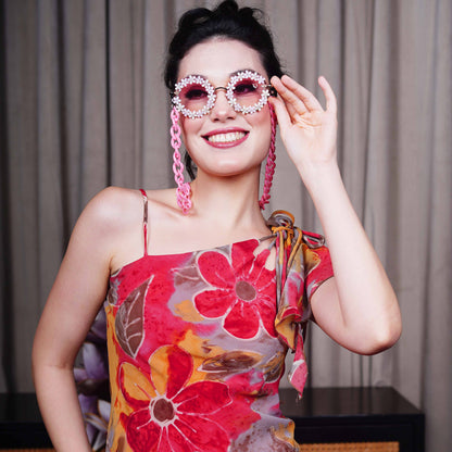 Elegant round sunglasses with floral crystal-studded finishing, adorned with a pink funky chain for a playful vibe-front view