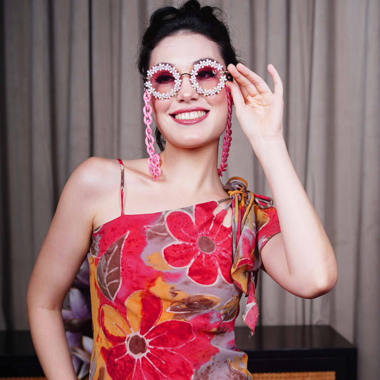 Elegant round sunglasses with floral crystal-studded finishing, adorned with a pink funky chain for a playful vibe-front view