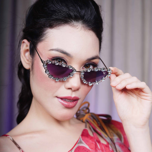 Cat-eye sunglasses with dark purple lenses and a rhinestone-embellished frame-styling view