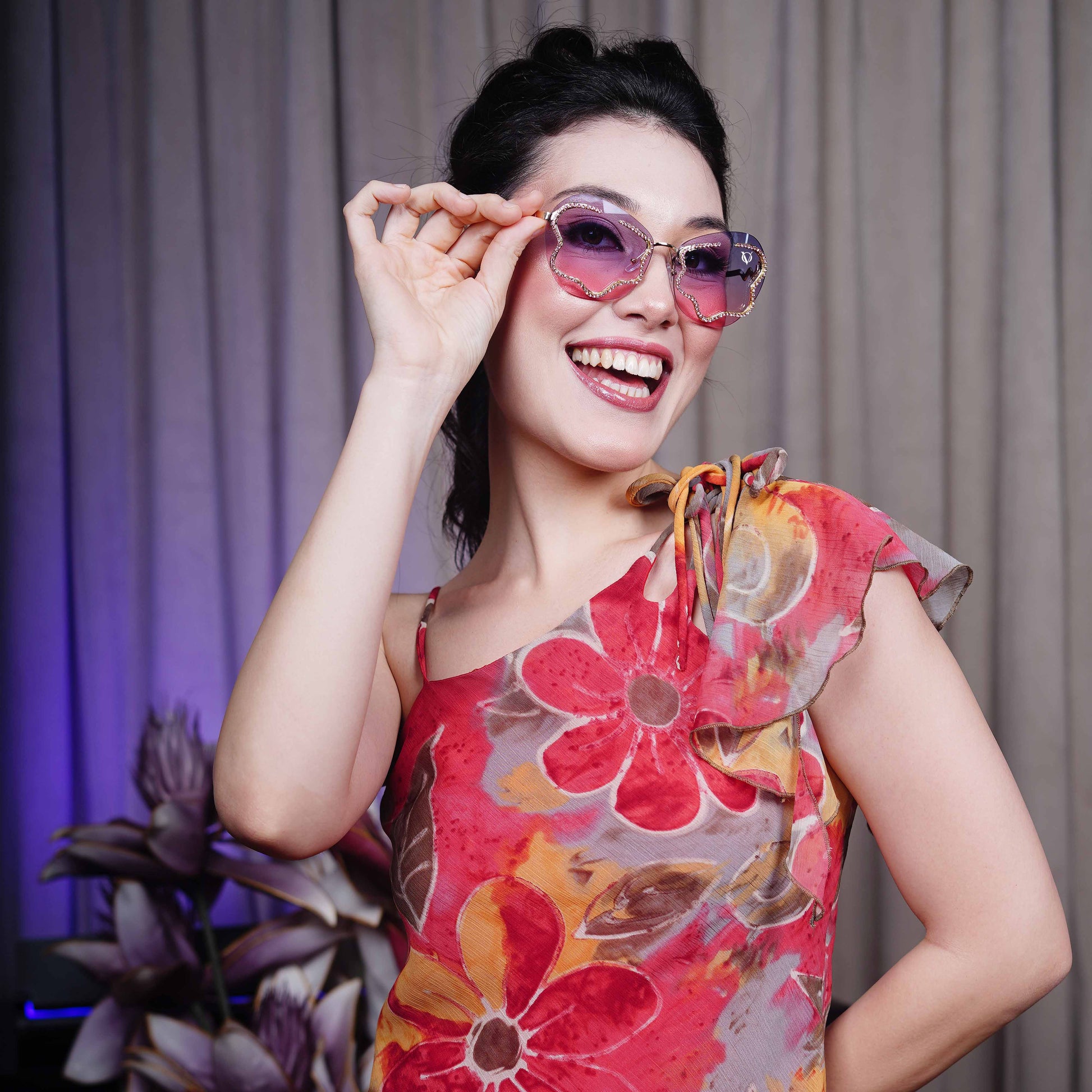 stylish heart-shaped sunglasses with purple-pink gradient lenses and a decorative golden frame-smiling view