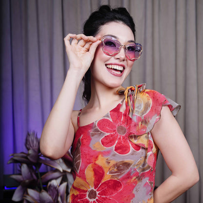stylish heart-shaped sunglasses with purple-pink gradient lenses and a decorative golden frame-smiling view