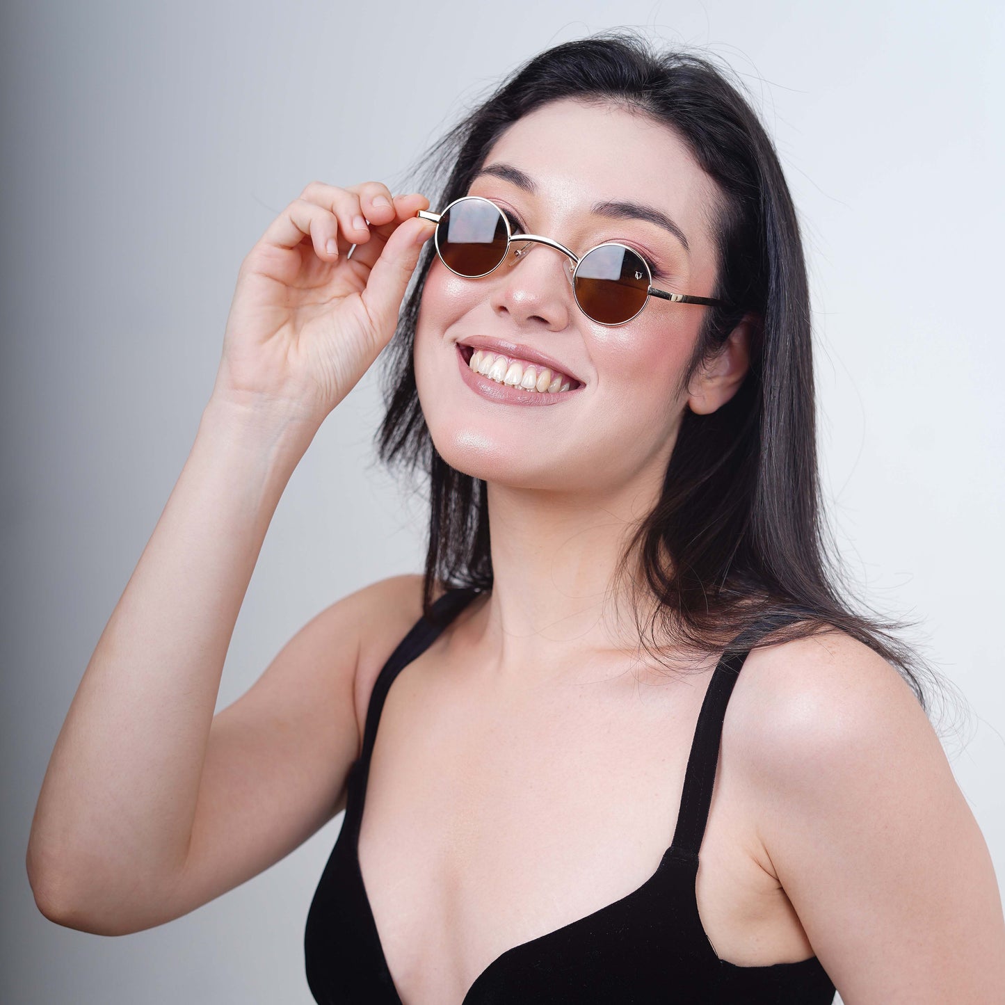 Round sunglasses with golden metallic frame and brown tinted lenses-side view