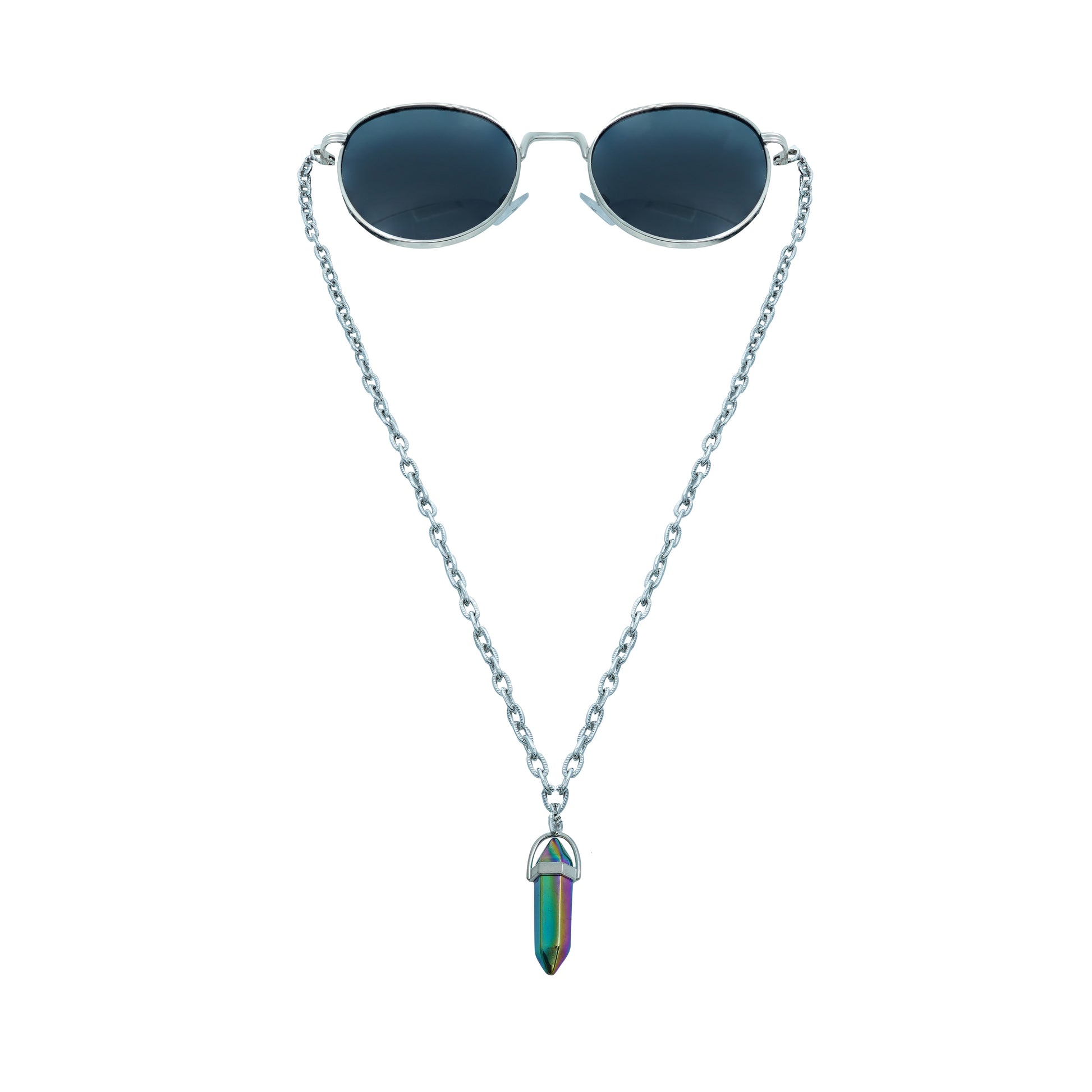 A pair of round, dark-lensed sunglasses with a silver frame is connected to a silver chain, which holds a pendant shaped like a crystal or bullet, featuring a rainbow metallic finish-front view