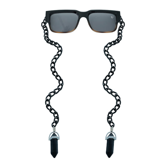 Black rectangular sunglasses with a decorative black chain strap and black crystal charms attached at the ends-front view
