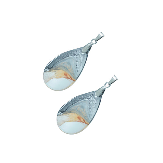 Teardrop-shaped glass pendants with a gold and crystal silver swirl design and silver hooks-angle view