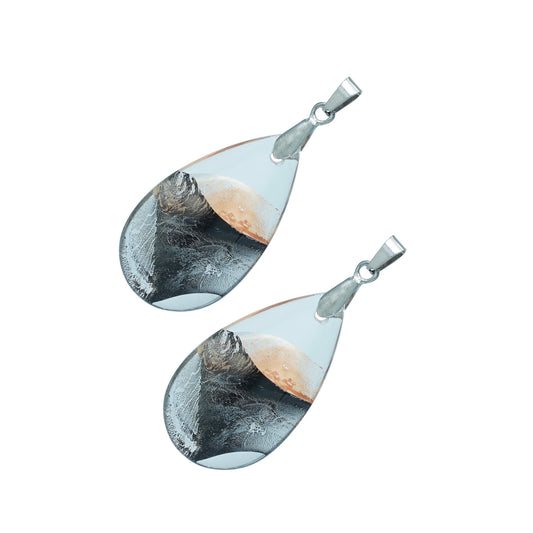 Teardrop-shaped glass pendants with a gold and black swirl design and silver hooks-angle view
