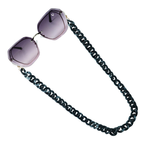 Sunglasses with purple gradient hexagonal frame lenses attached to a bold chunky black chain-angle view
