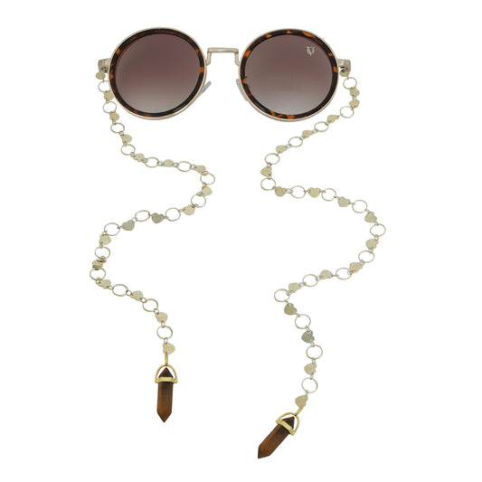 Round sunglasses with dark lenses, a tortoise-shell detailing frame, and a dual-link gold chain strap, or oval rings and leaf discs featuring tiger-eye charms-front view